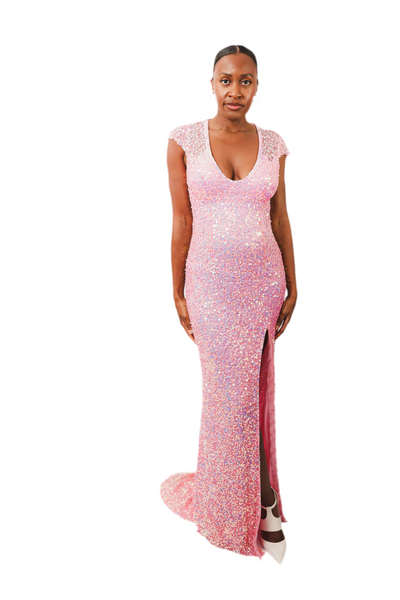 Woman wearing Olivia Pink Sequin Dress with thigh slit and cap sleeves.