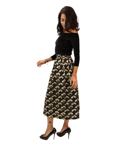 Charlotte Black Gold Midaxi Skirt with floral design, worn with a black off-the-shoulder top.