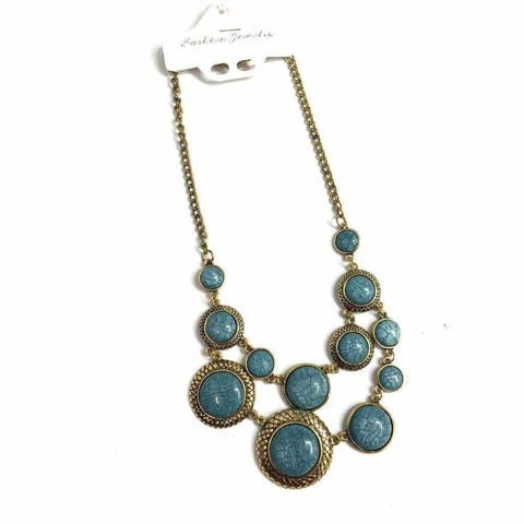 Blue stone necklace with dusky gold metal chain.