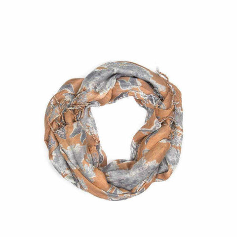 Burnt orange scarf with grey leaf print and tassel trim.