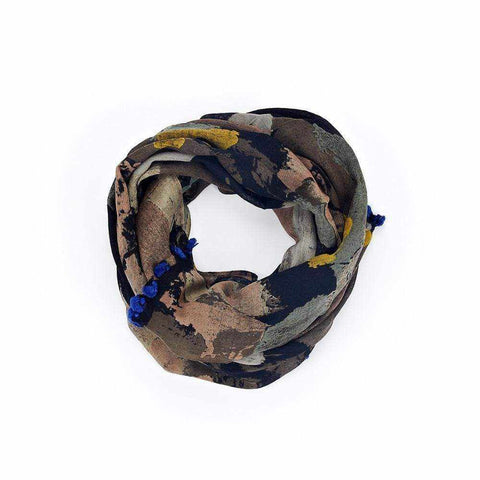Dark blotch print scarf with electric blue pom pom trim by Abbacino.