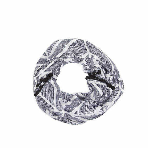 Geometric print scarf with black tassel trim.