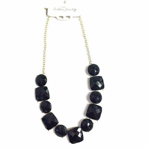 Geometric stone necklace with black stones on a gold metal chain.